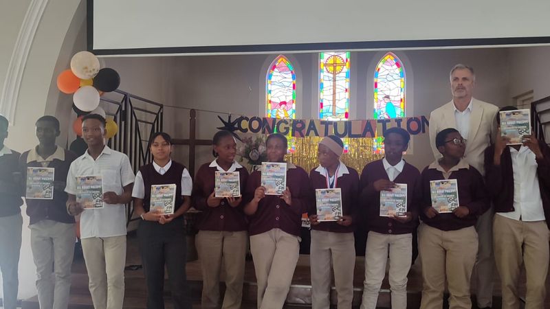 Learners holding their certificates at assembly