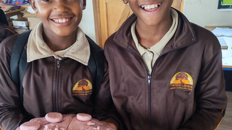 Two learners showing what they baked
