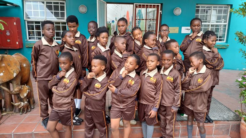 Learners gathered together outside their classrooms